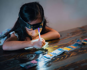 Side view of boy playing with jigsaw piece