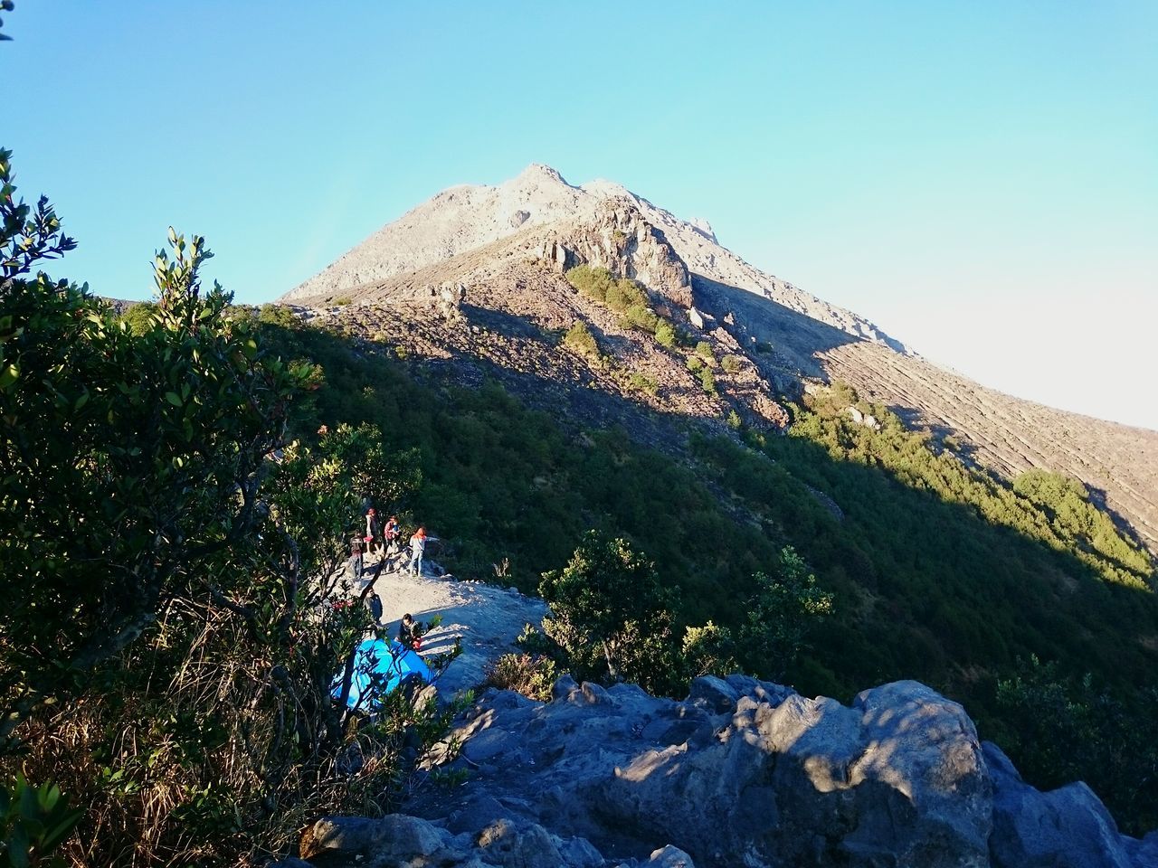 mountain, clear sky, tranquility, tranquil scene, scenics, mountain range, landscape, beauty in nature, rock formation, nature, rock - object, non-urban scene, rocky mountains, physical geography, blue, geology, sunlight, remote, idyllic, cliff