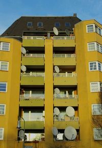 Low angle view of yellow building against clear sky