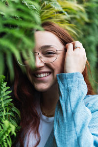 Beauty natural woman covering her face with tropical leaf