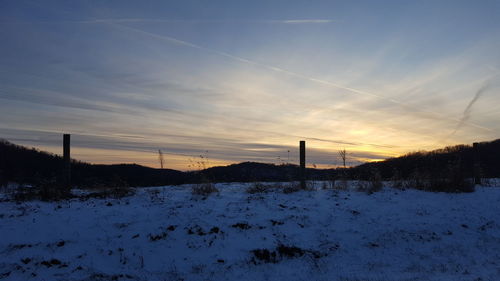 Snow covered landscape against sky