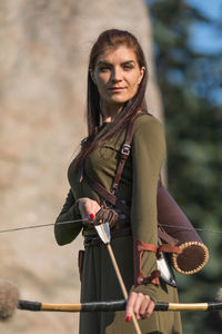 Portrait of young woman standing outdoors