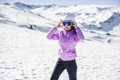 Woman wearing ski clothing getting ready to ski at the sierra nevada, andalusia, spain