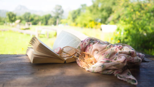 Side view of young woman sleeping on book