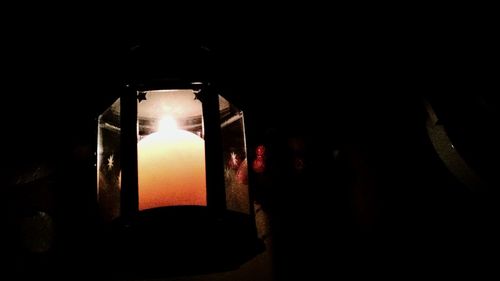 Close-up of illuminated lamp in darkroom