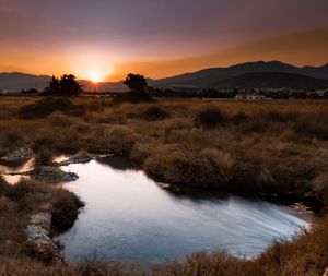 Scenic view of land against sky during sunset