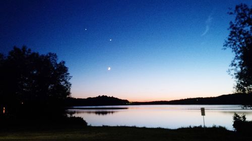 Scenic view of lake against sky at dusk