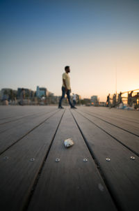 Close-up of man on pier against sky