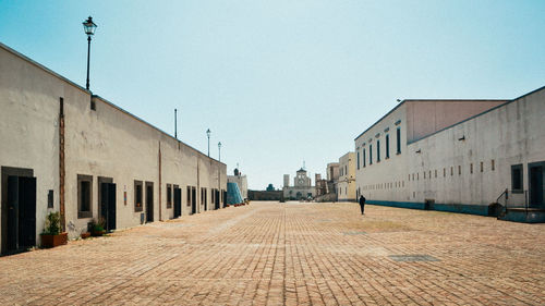 Street amidst buildings against sky