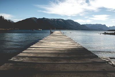 Pier over lake against sky