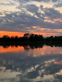 Scenic view of lake against orange sky