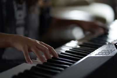 Cropped hand playing piano