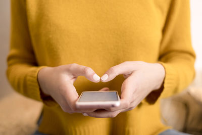 Midsection of woman using mobile phone