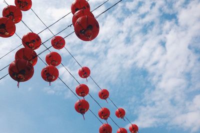 Low angle view of lanterns hanging against sky