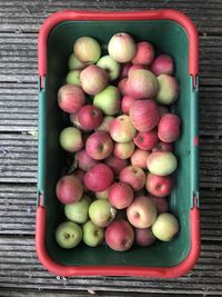 High angle view of apples in container on table