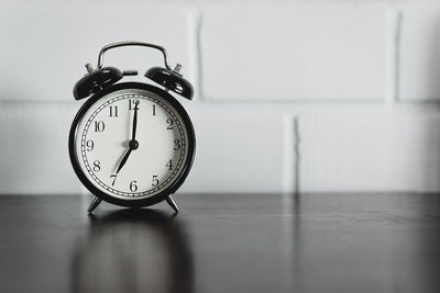 Close-up of clock on table at home
