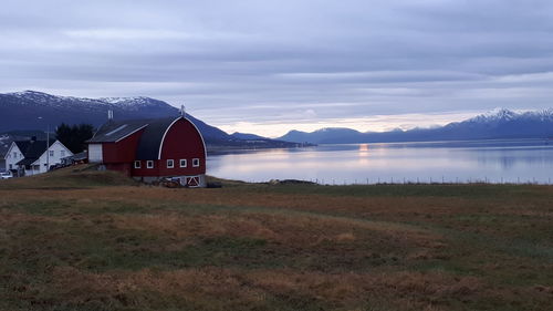 Scenic view of lake by mountains against sky