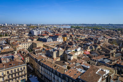 High angle shot of townscape against blue sky