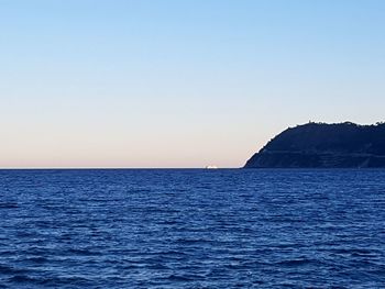 Scenic view of sea against clear blue sky