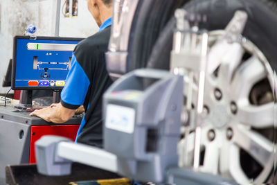 Mechanic using computer at garage