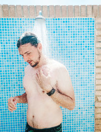 Full length of shirtless man in swimming pool