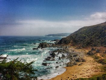 Scenic view of sea against cloudy sky