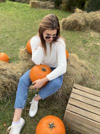 Young woman playing with toys on field