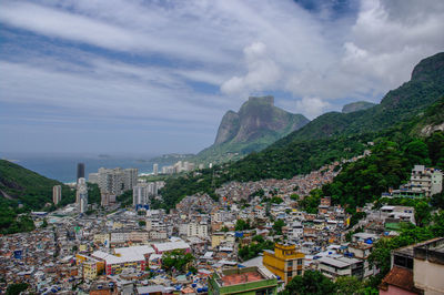 View of cityscape against cloudy sky