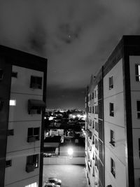 Illuminated buildings against sky at night