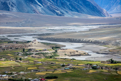 High angle view of landscape and snowcapped mountains