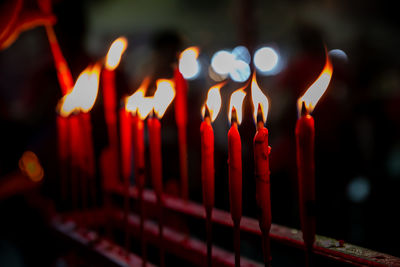 Close-up of lit candles in temple