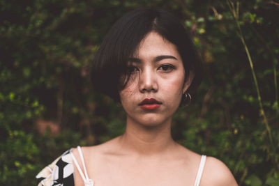 Portrait of a beautiful young woman standing outdoors