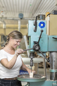 Smiling woman working in workshop