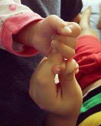 Close-up of hands holding baby hand