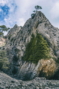 Low angle view of rock formation against sky