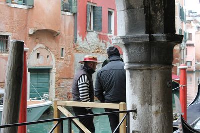 Rear view of people walking on building