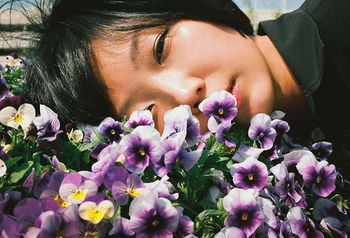 CLOSE-UP OF WOMAN HOLDING PINK FLOWERS