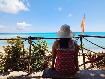 Rear view of woman looking at sea against sky