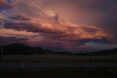 Scenic view of mountains against cloudy sky