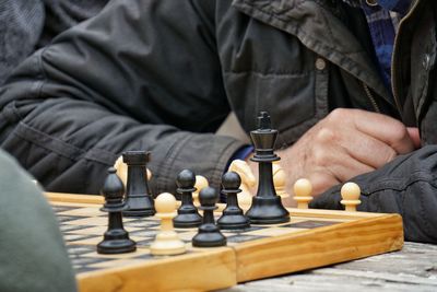 Midsection of man playing chess