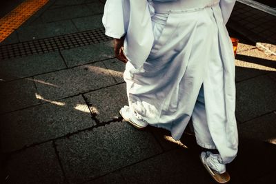 Low section of man standing on footpath