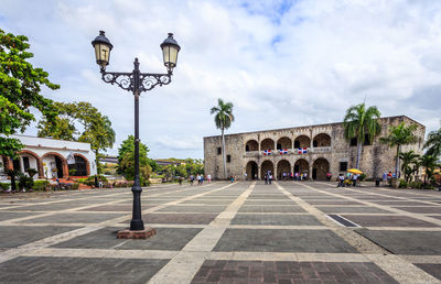 People walking on street against building