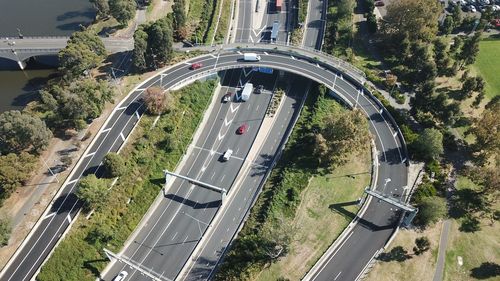 High angle view of highway amidst trees in city