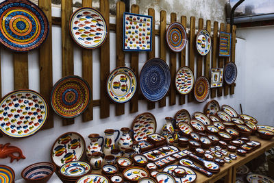 Collection of colorful pottery from a local craft store on display. handmade ceramic gift shop