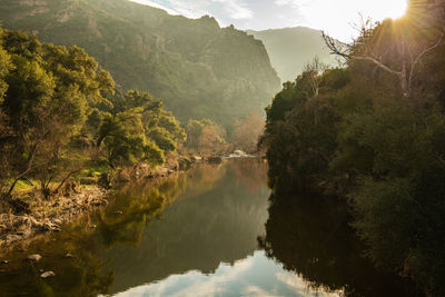 Scenic view of lake and mountains against sky