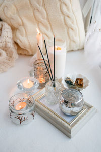 High angle view of illuminated candles on table