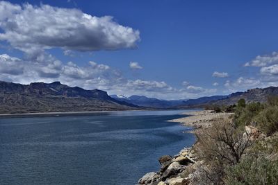 Scenic view of sea and mountains against sky