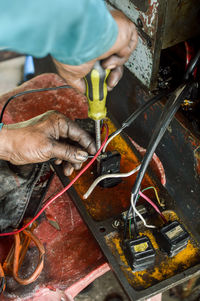 High angle view of man working on metal