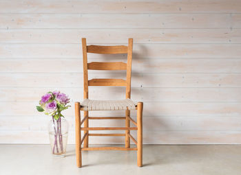 Empty chairs and table against wall at home