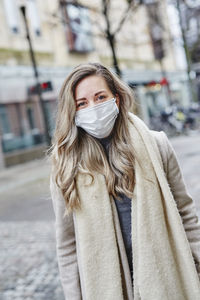 Portrait of woman standing on street in city